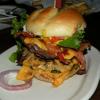 This is an atrocious facsimle of a Cheeseburger. It looks somethign like the Leaning
Tower of Pizza, but it is an 
actual burger on Ray's 
menu. It is called the Mo-Fo Burger, and looking at it I would say it is one Big Mo-Fo!