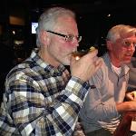 And here is S. B. embibing a
Dirty Martini.  
His signature drink every week is at least one Martini at 
the end of the evening. So this
was a natural. 
Sitting next to him is The Forester. John made an appearance on this eveing. 