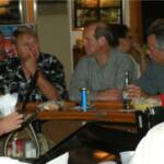 From L-R are DRUMSTIR, R. B., and BILLY BOB kidding around with KAREN at the bar. 